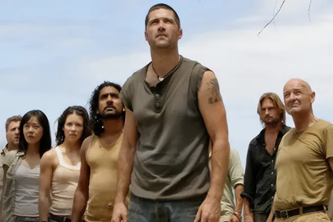Survivors from the TV show Lost standing together on a beach, looking determined and focused.