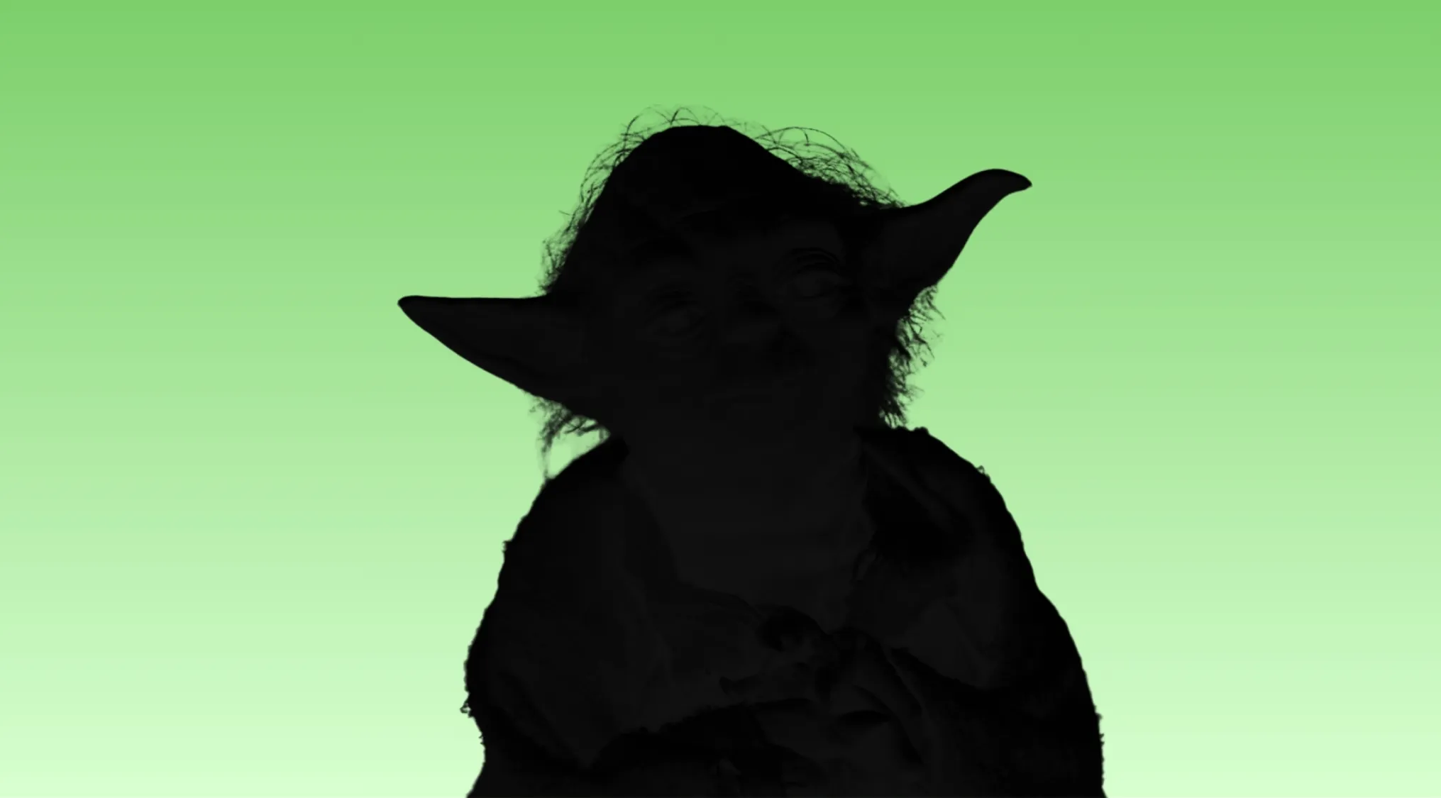 Silhouette of a famous movie character with large ears against a green background for guess the movie character quiz.