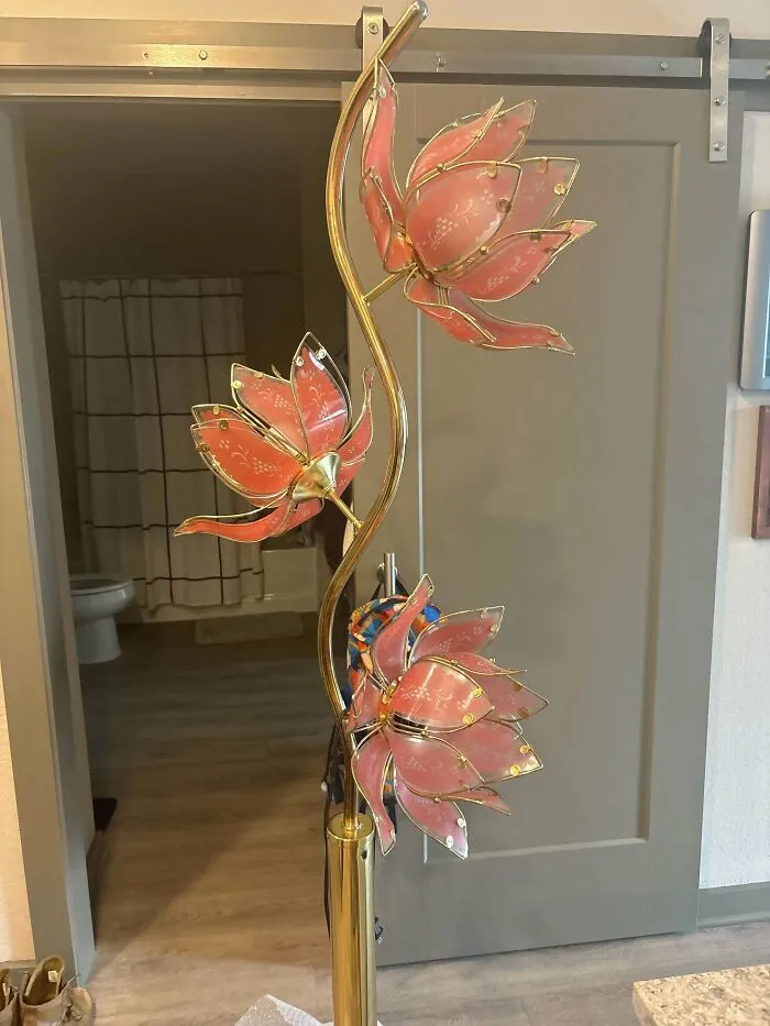 A unique floor lamp with three pink, lotus-shaped lights, found as a thrift store jackpot.