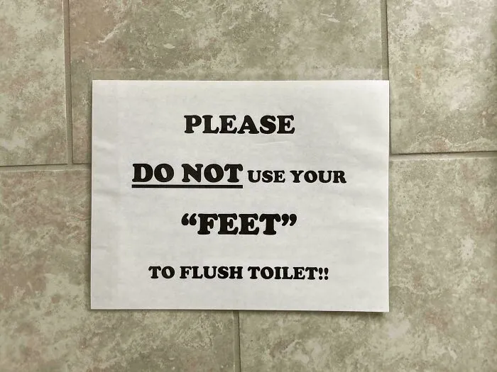 Sign with suspiciously placed quotation marks around the word feet, humorously warning against using them to flush toilet.