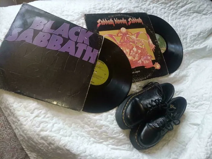 Two Black Sabbath vinyl records and a pair of black boots, a cool haul from dumpster diving.