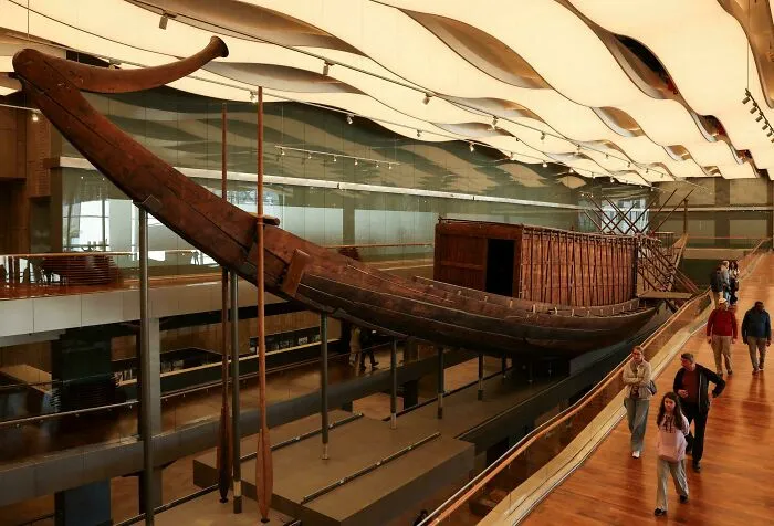 Large ancient wooden ship suspended inside a museum, one of the top historical finds.