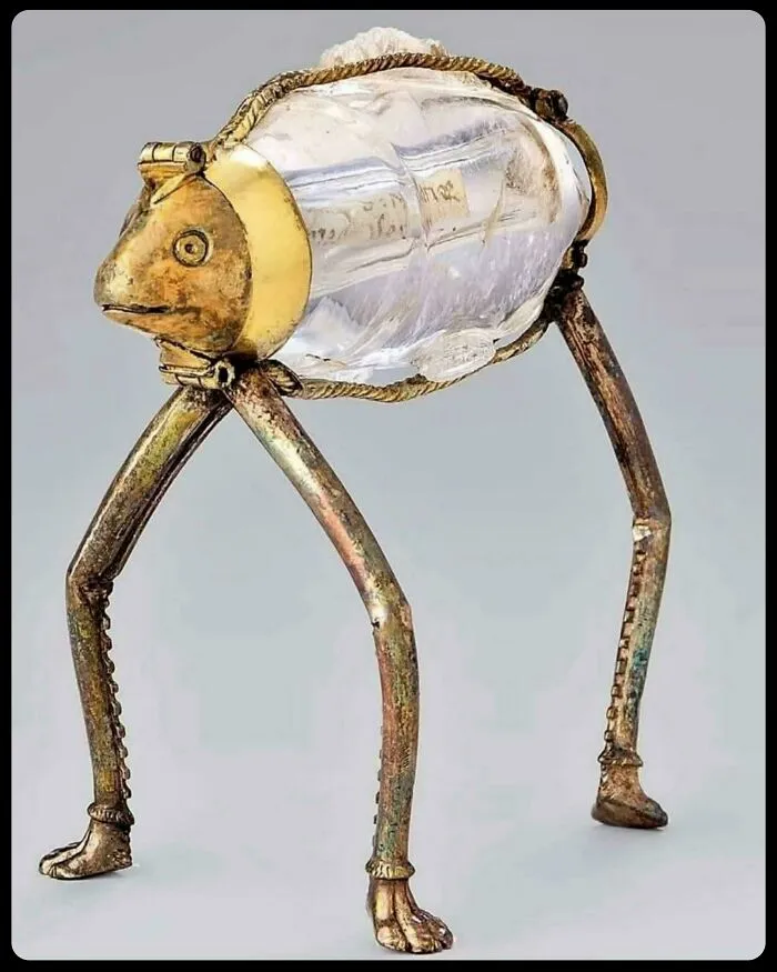 An ornate frog-shaped crystal container with golden legs, showcasing unique historical finds.