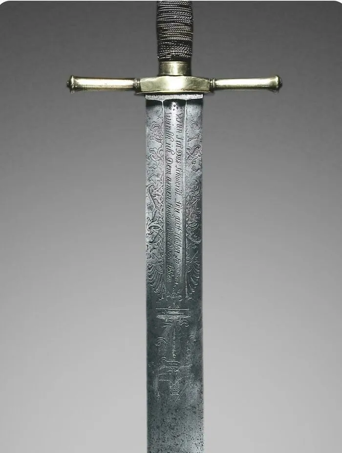 Close up of an intricately engraved historical sword blade featured among historical finds.