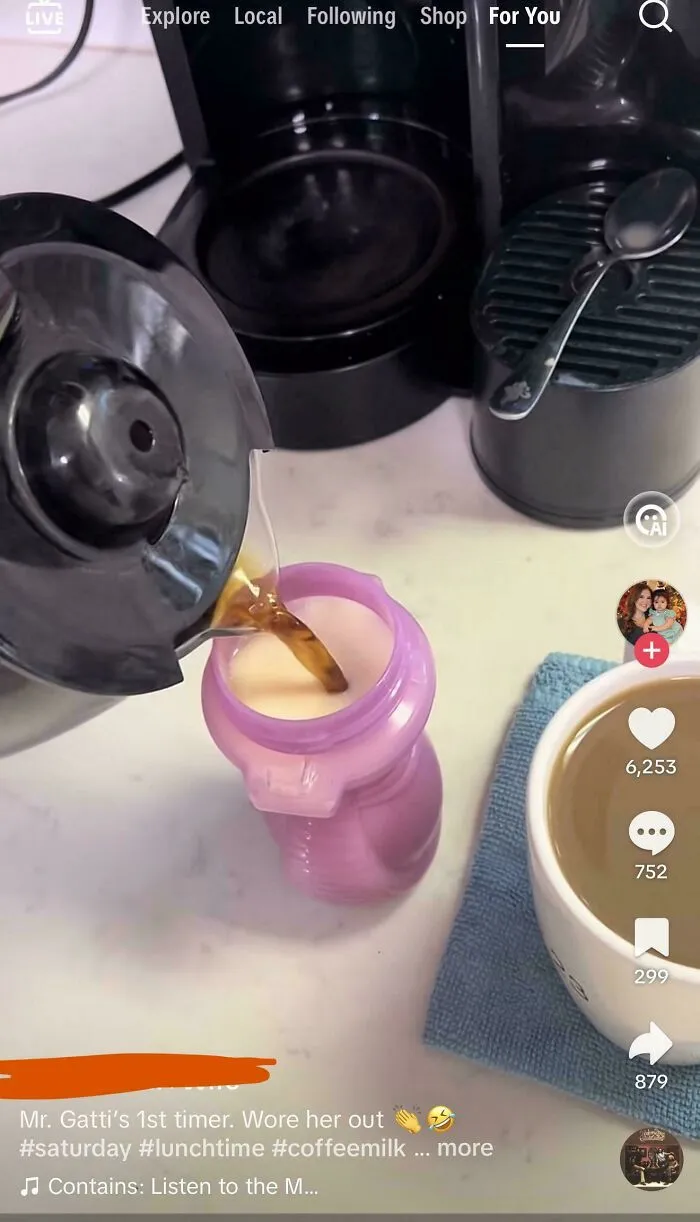 Pouring coffee into pink baby bottle near cup on kitchen counter