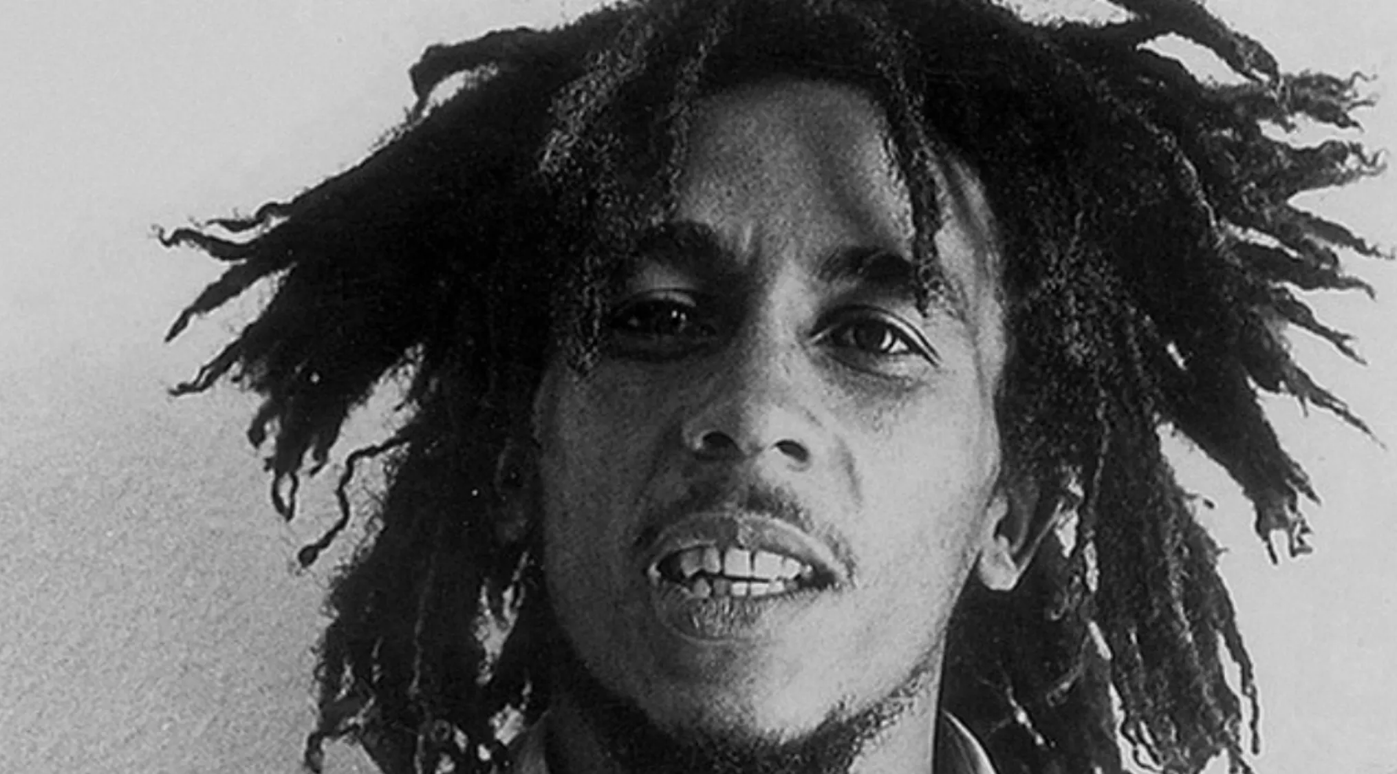 Black and white close-up portrait of Bob Marley with natural hair, related to famous last words quiz keyword.