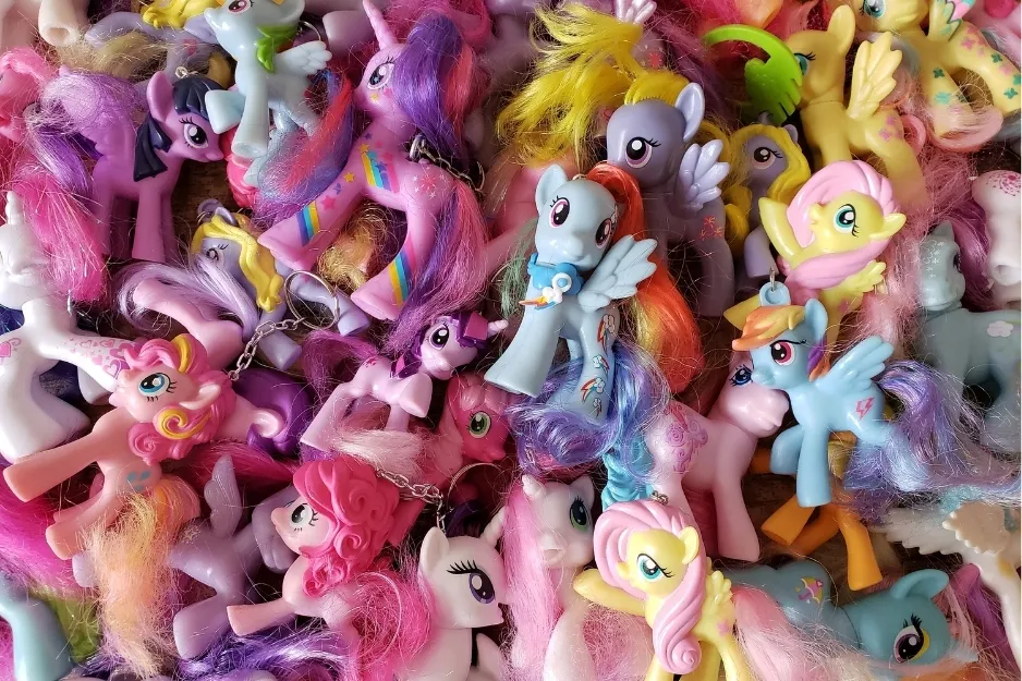 Assortment of colorful My Little Pony toys with various hairstyles and accessories from different generations.