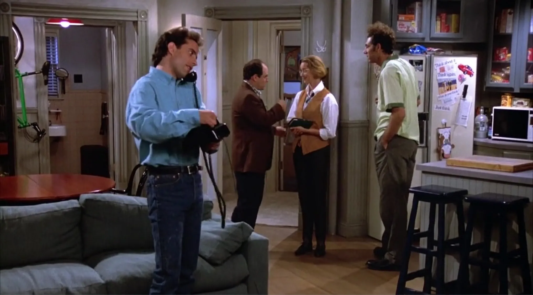 Scene from the sitcom Seinfeld showing characters Jerry, George, Elaine, and Kramer in an apartment setting.