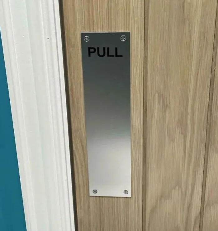 Door with a metal plate labeled pull, illustrating funny posts about how uncultured and ignorant Americans can be.