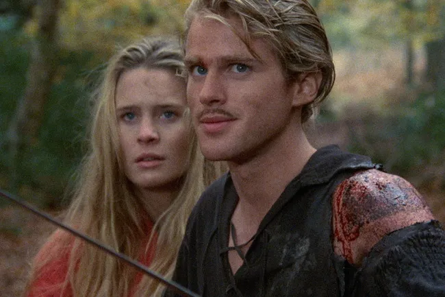 Westley and Buttercup from The Princess Bride in a forest scene, preparing for an adventurous moment with visible tension.
