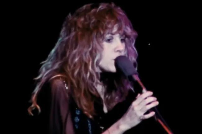 Female singer performing Dreams by Fleetwood Mac, ideal music choice for a dinner party playlist.