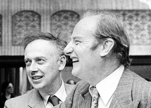 Watson and Crick in a black and white photo, discussing the DNA structure they described in 1953.