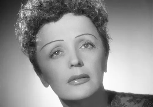 Black and white portrait of French singer Édith Piaf, known as The Little Sparrow, from the 1950s era.