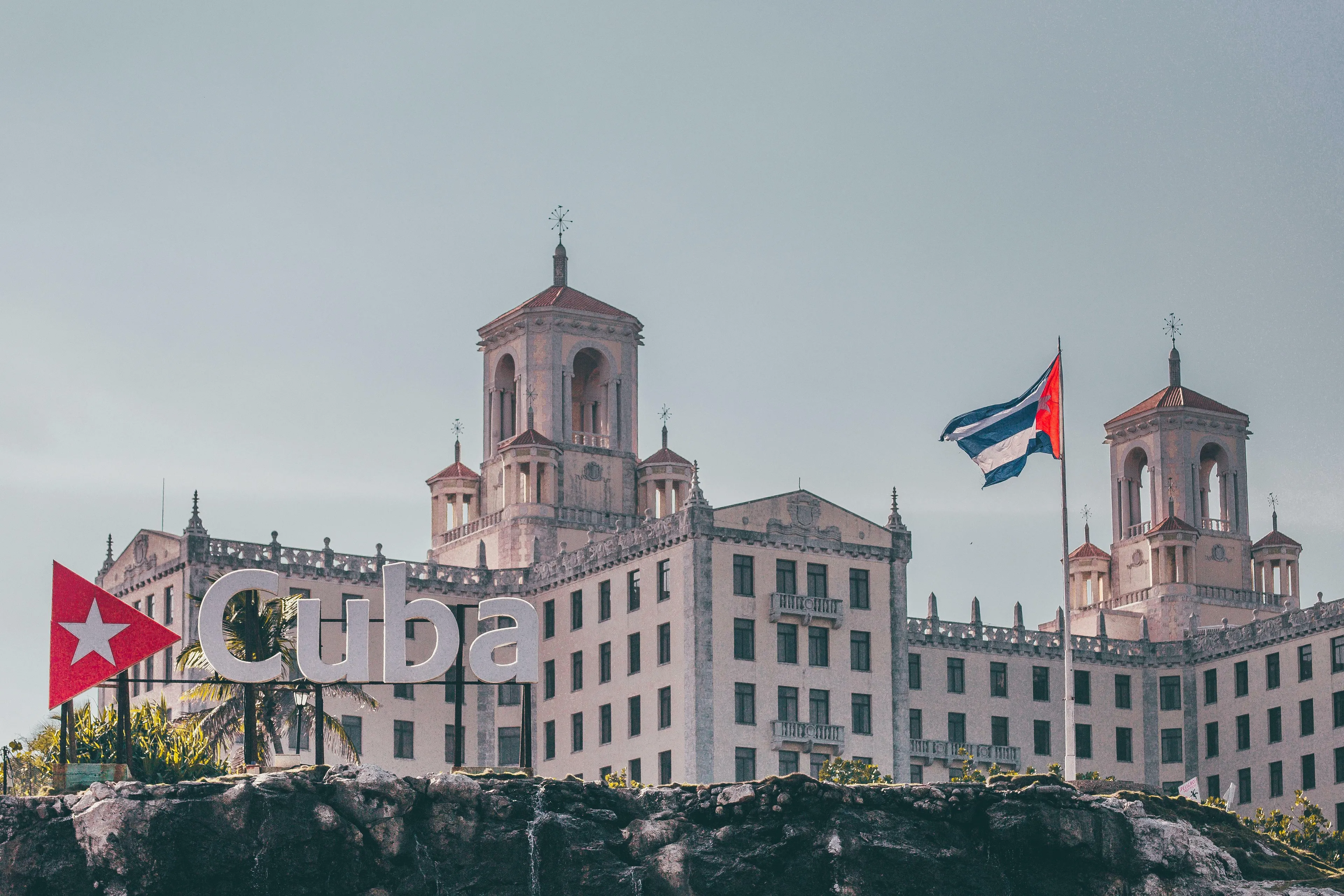 Historic Cuban building with a flag and Cuba sign representing the dance originating in Cuba and 1950s ballroom craze