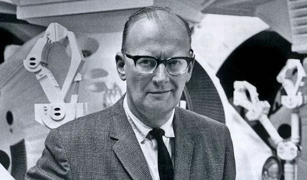 Black and white photo of British author Arthur C Clarke wearing glasses and a suit in a vintage science fiction setting.