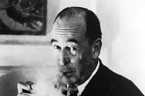 British author smoking a pipe in a black and white photo, related to The Lord of the Rings trilogy and C.S. Lewis.