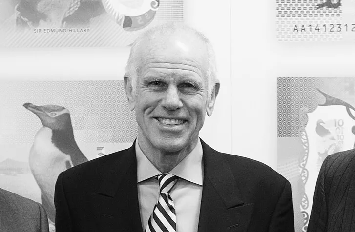 Black and white photo of Peter Hillary, New Zealand mountaineer and son of Sir Edmund Hillary, smiling in formal attire.