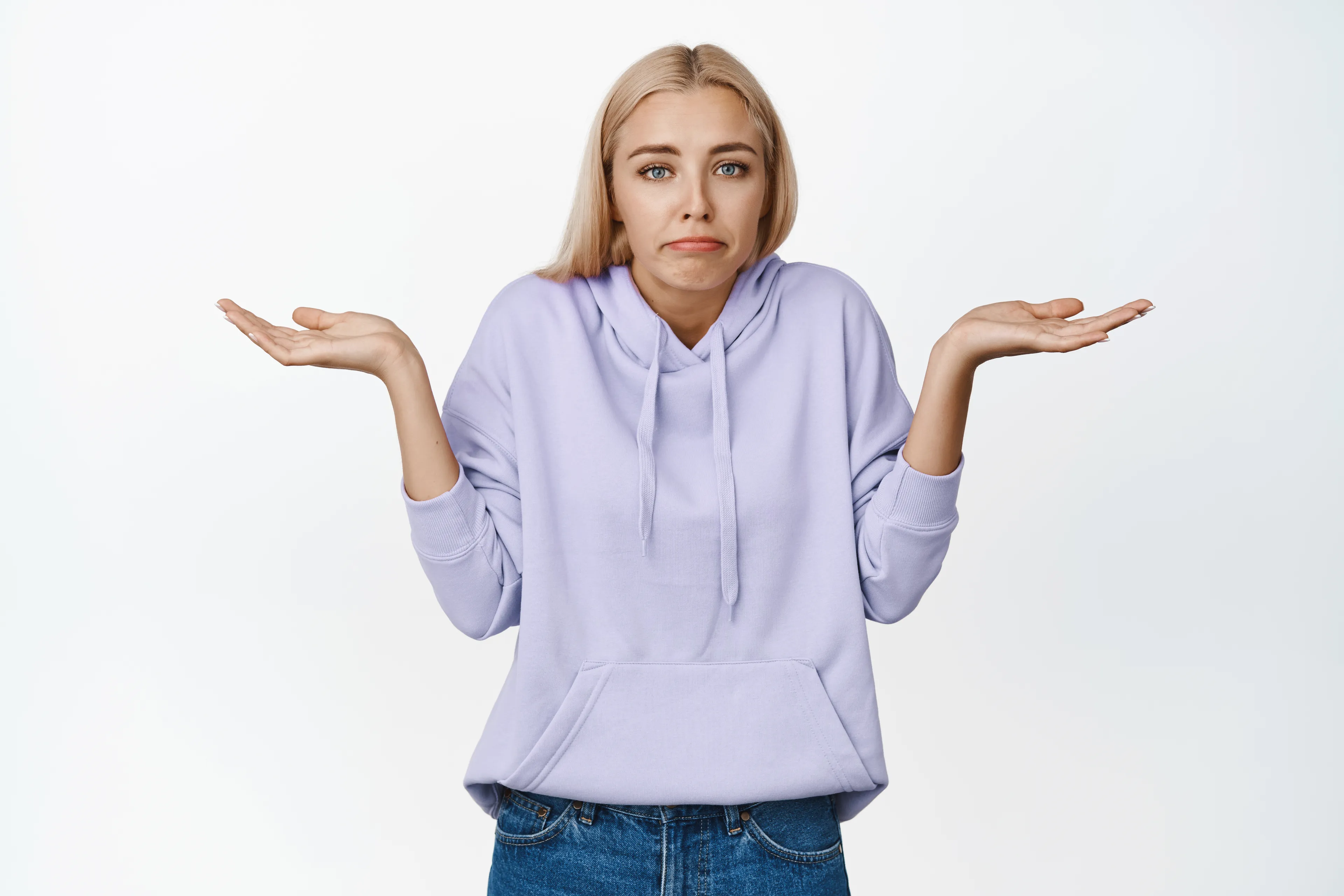 Young woman in casual hoodie shrugging shoulders expressing no plan for a friend's evening, ready to improvise the plan