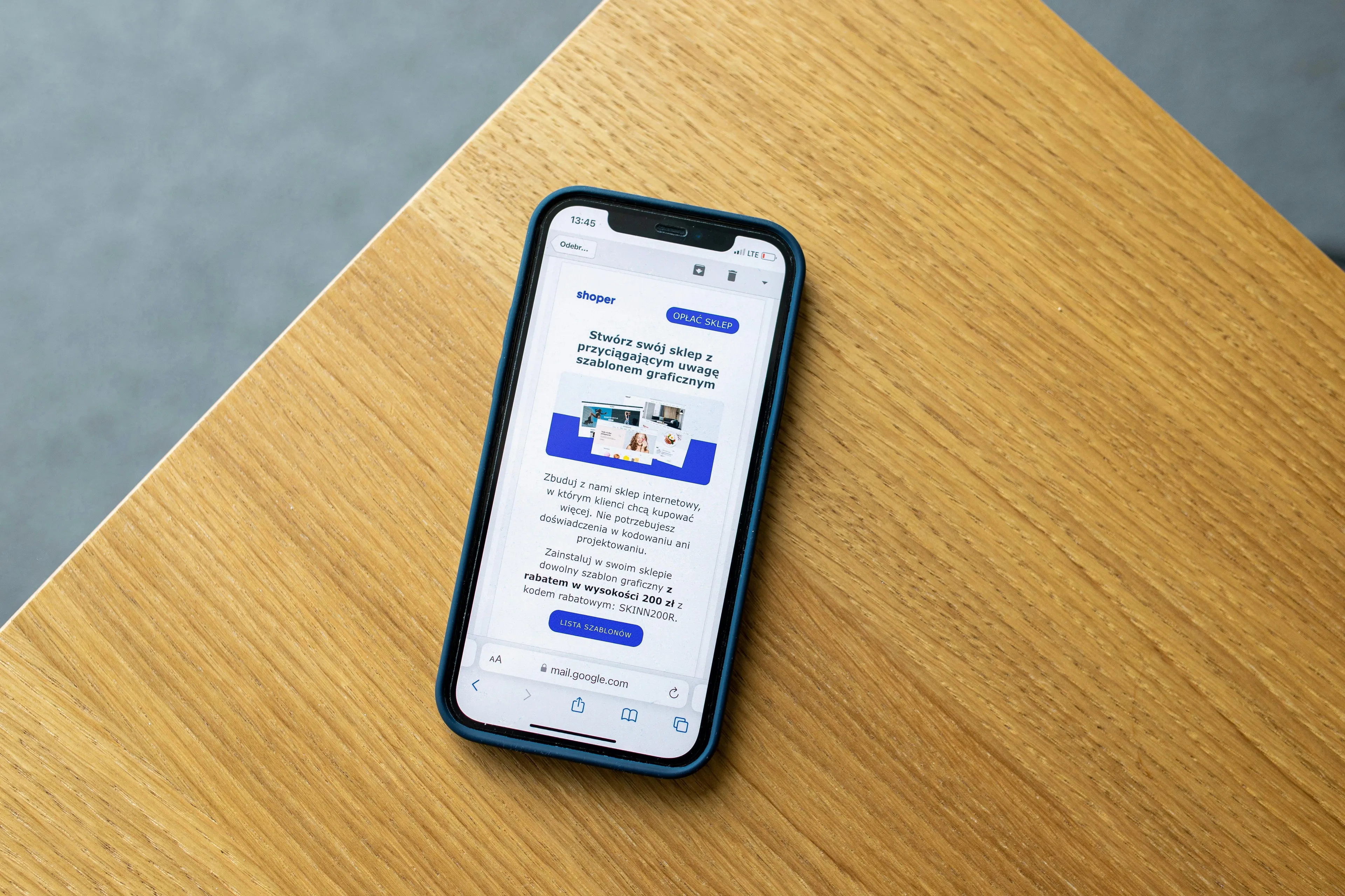 Smartphone on a wooden table showing a flash sale email for a gadget, testing if you can control your urges.