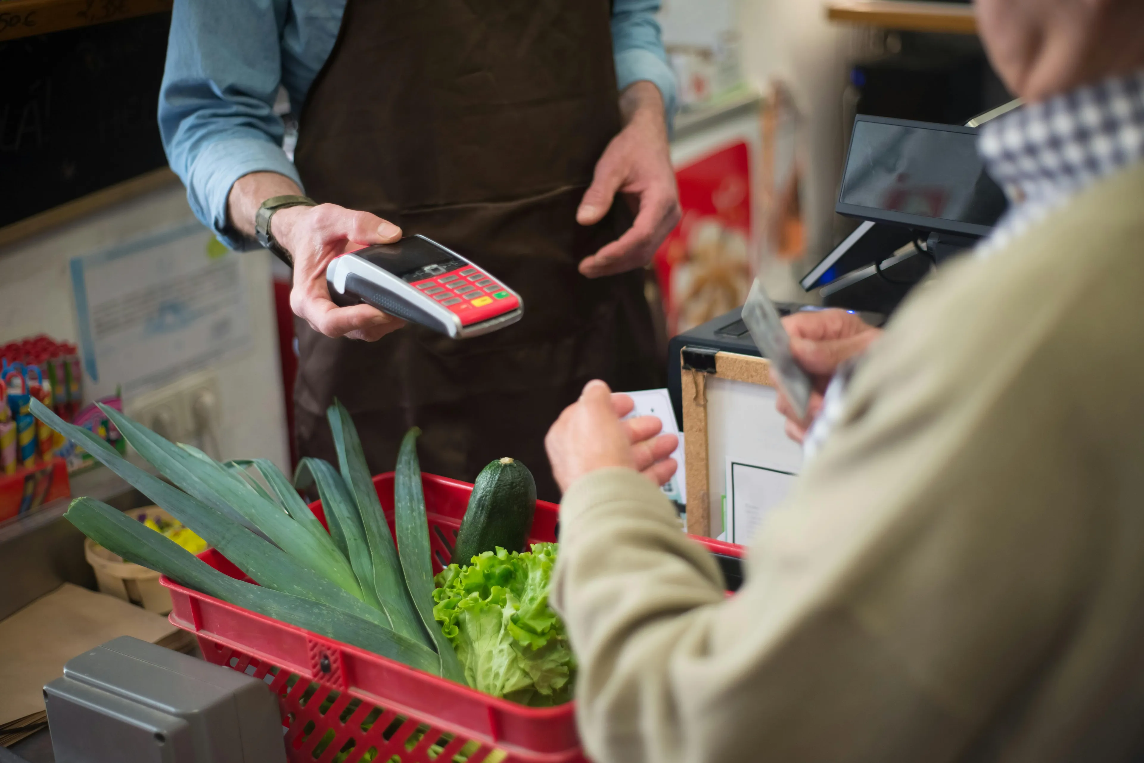 Customer paying with card at supermarket express lane with more than allowed items, testing self-control over urges.