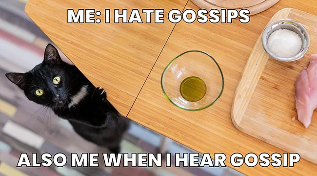 Black cat peeking over table, illustrating a trending meme about controlling urges related to gossip and temptation.