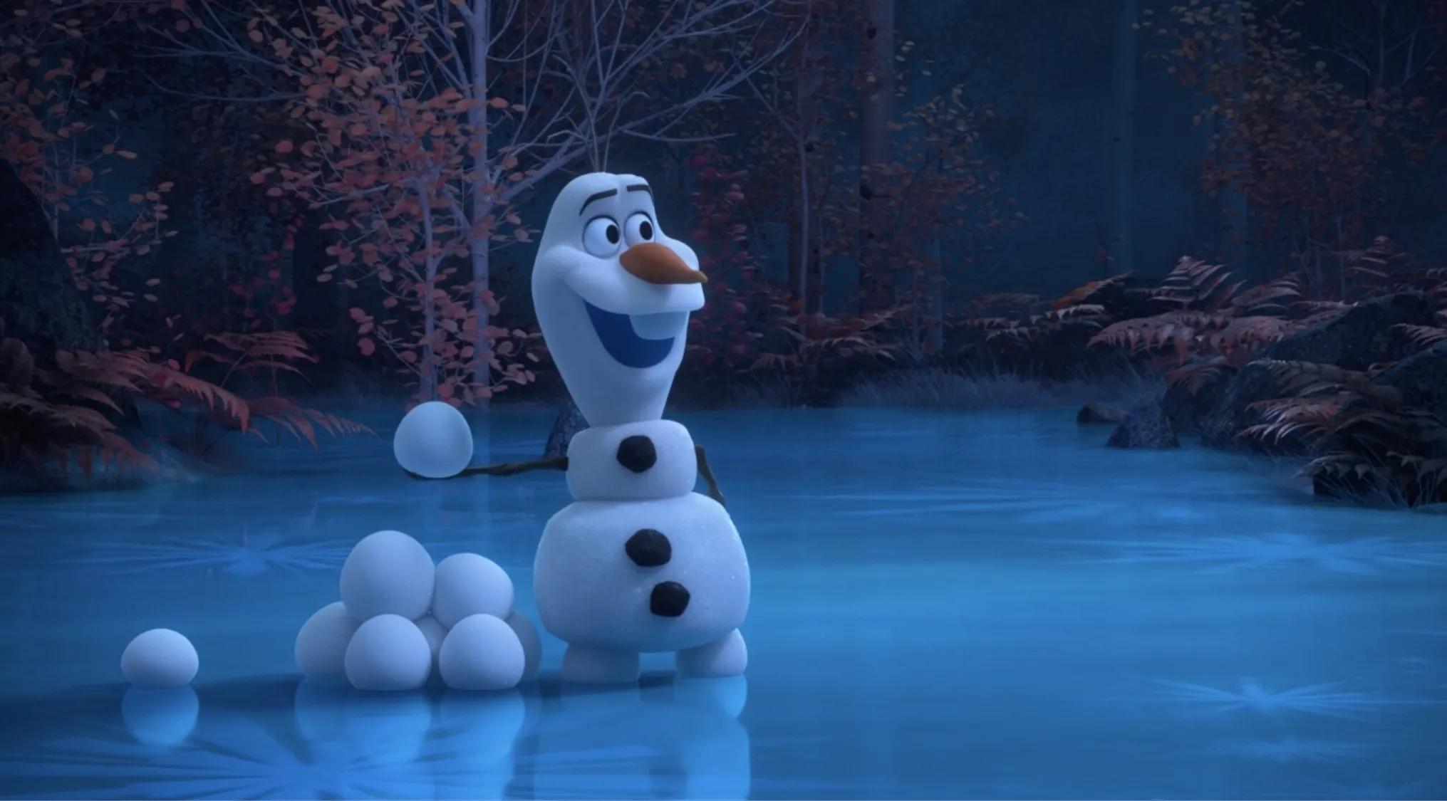 Olaf snowman from Disney’s Frozen standing on icy pond holding a snowball with snowballs stacked nearby in forest at night.