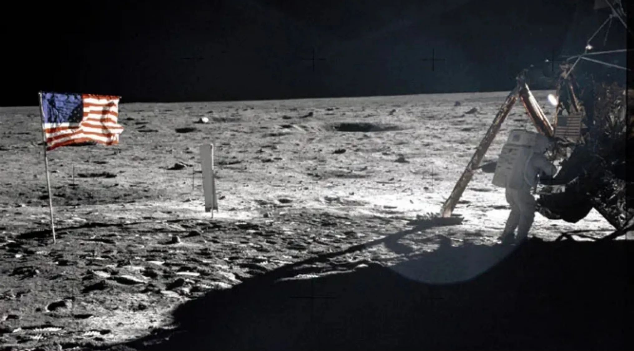 Astronaut on the Moon with American flag, illustrating the year humans first landed on the Moon historic event.