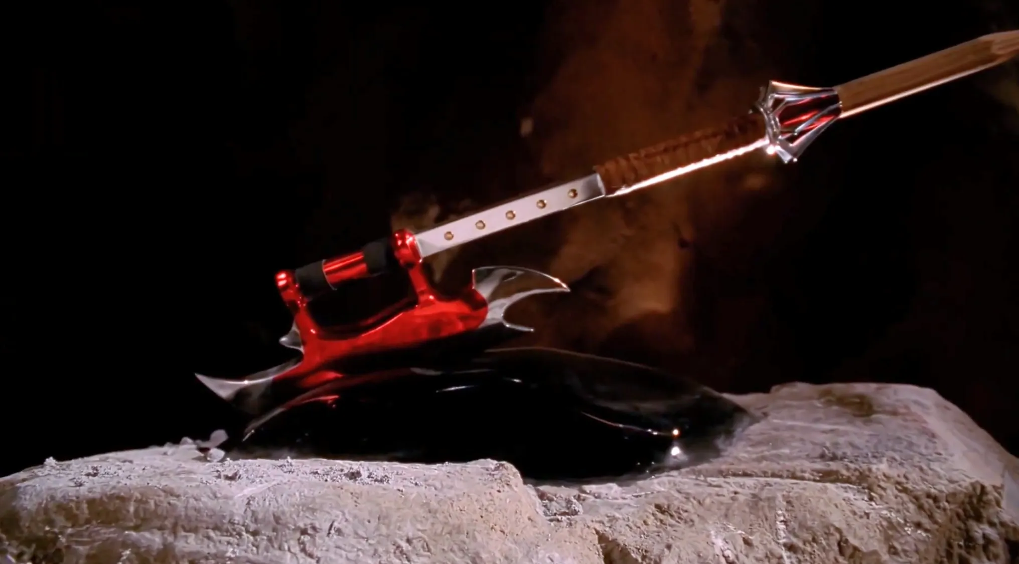 Close-up of a unique weapon prop resting on a stone surface from a popular TV show props quiz challenge.