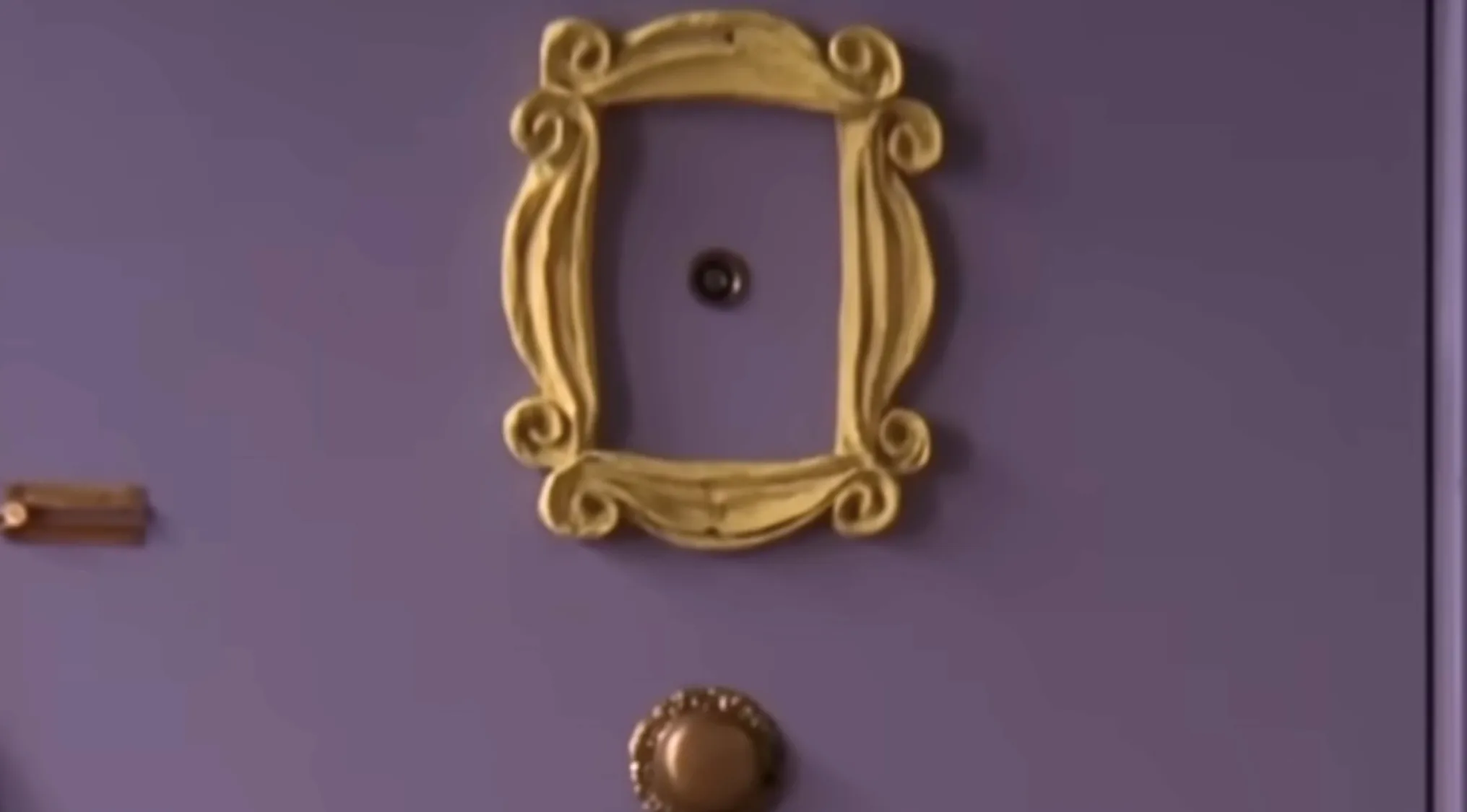 Ornate yellow frame around a peephole on a purple door, iconic TV show props quiz element displayed.