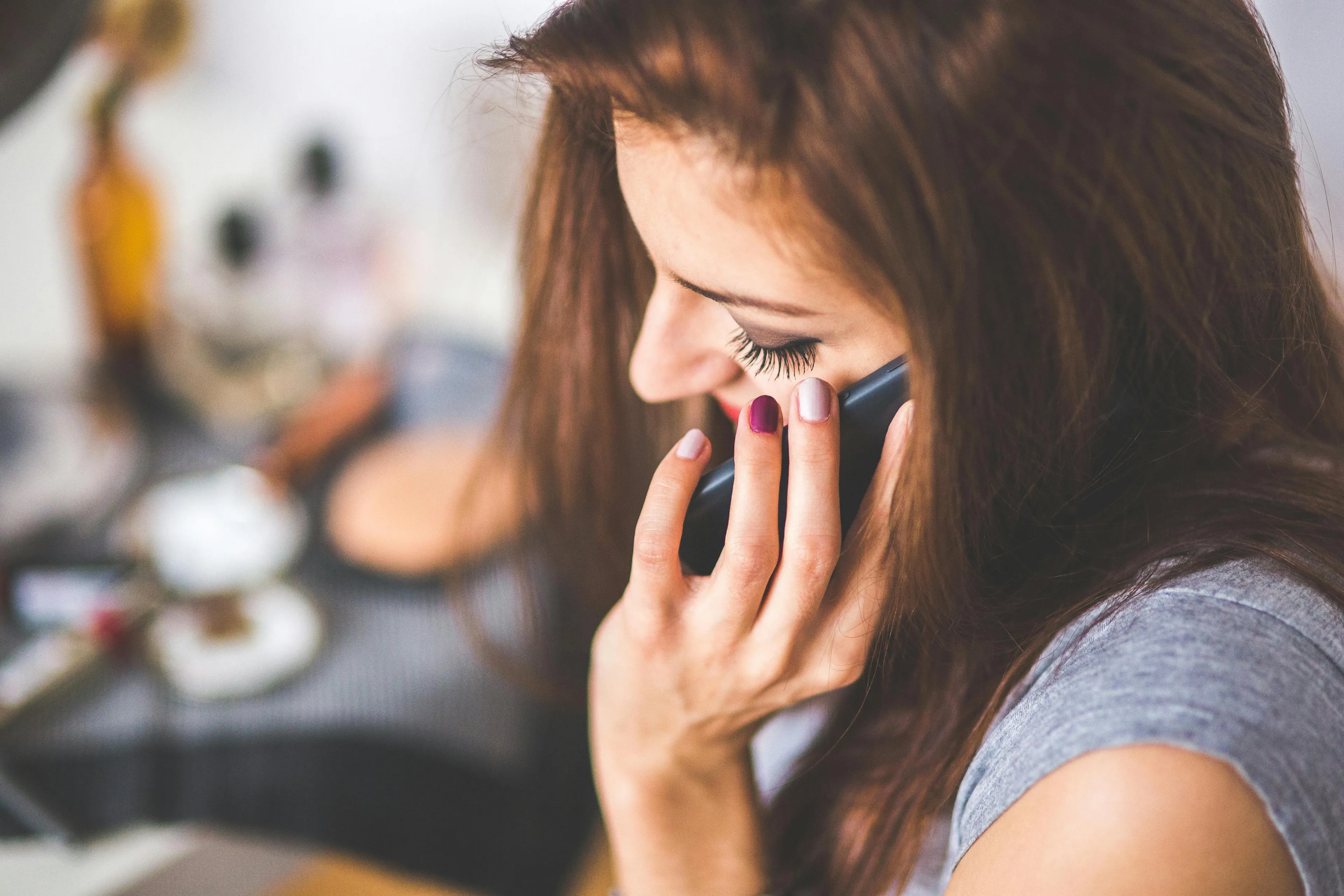 Young woman using her phone, focusing on decision making style decoder while choosing a new ringtone.