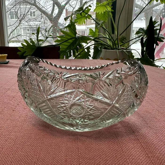 Clear glass bowl with intricate patterns placed on a dining table, showcasing weird and unhinged family traditions.