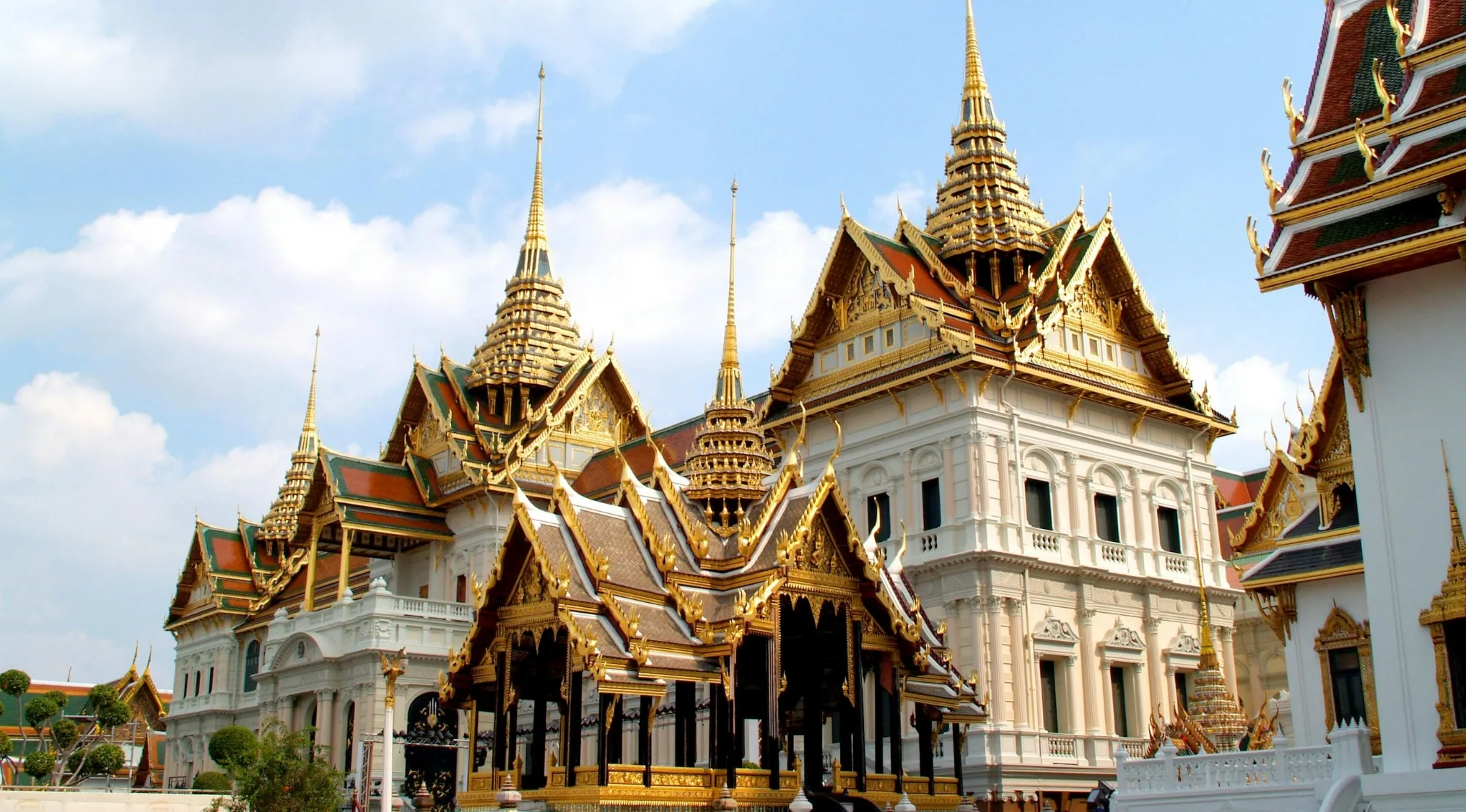 Grand Palace landmark with ornate golden roofs and spires, a geography challenge to guess the country from the visual hint.