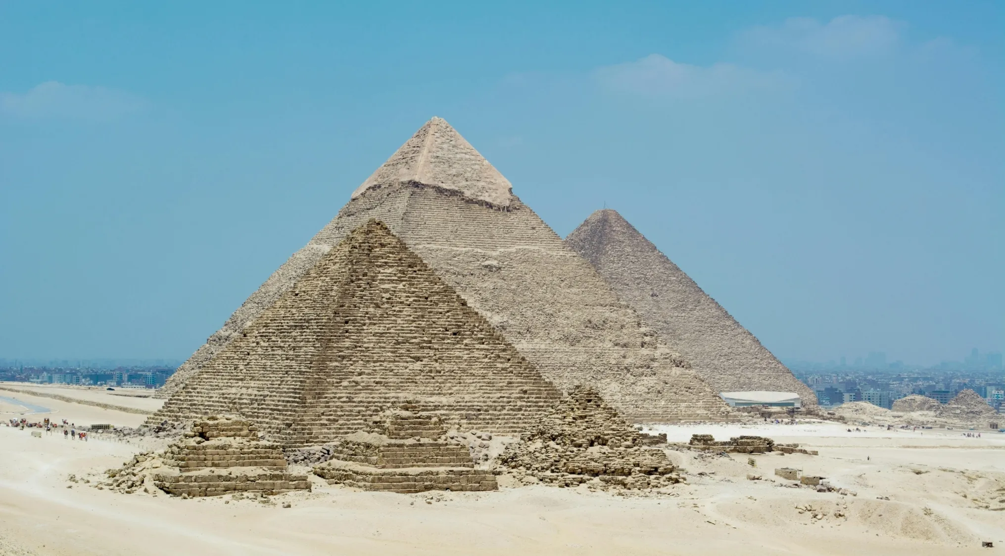 Ancient pyramids in a desert setting representing a geography challenge to guess the country of this landmark site.