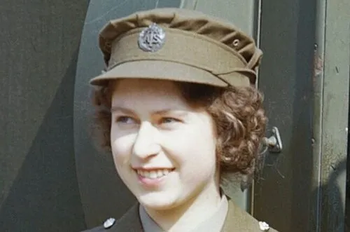 Young Queen Elizabeth II in military uniform, smiling during her early years before the historic 1953 coronation event.