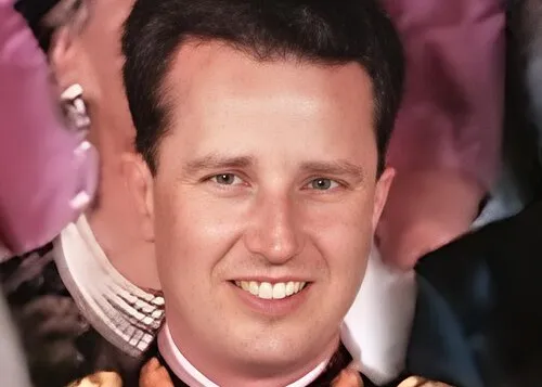 Portrait of a smiling young man in formal attire at a royal event, related to the 1953 televised coronation.