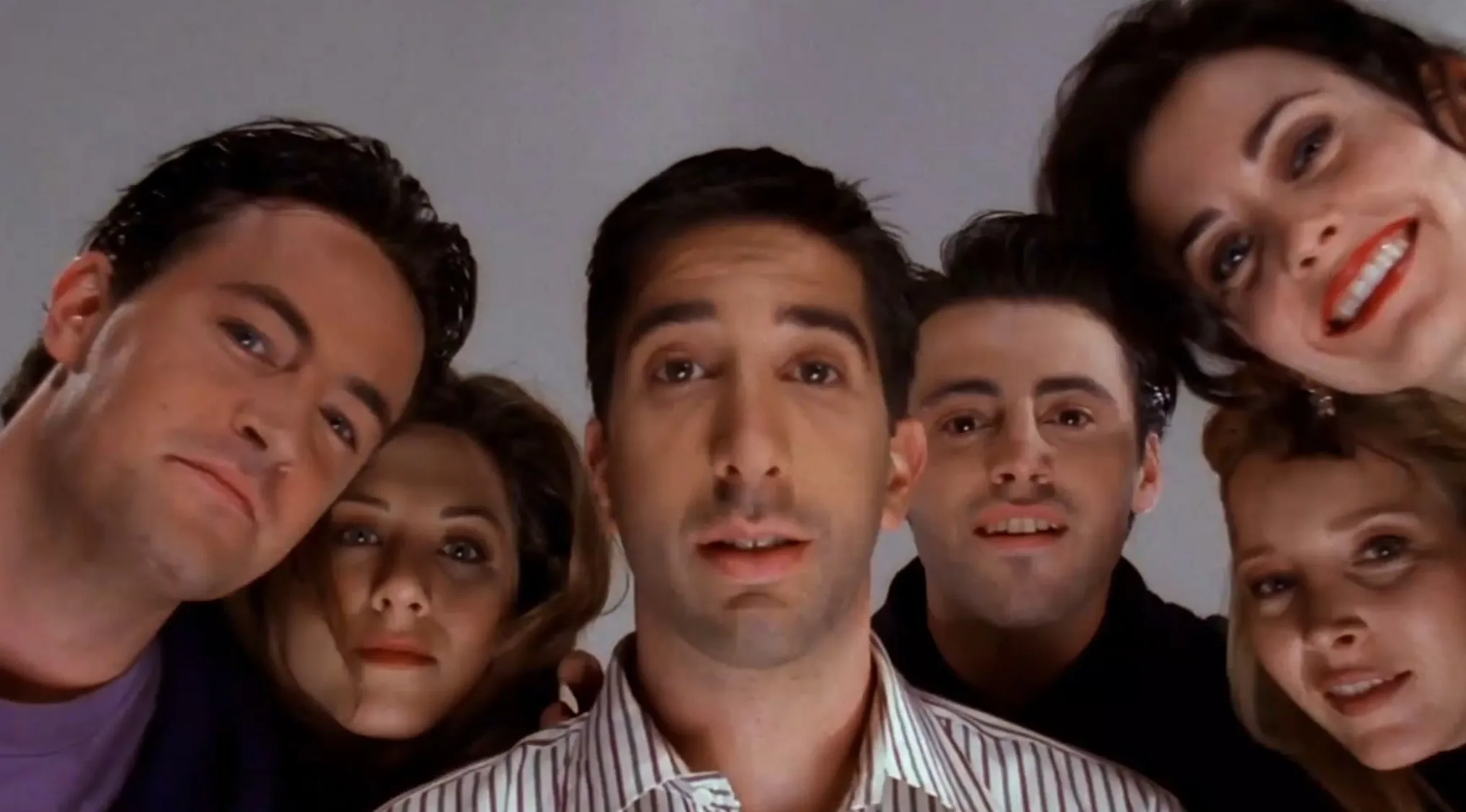 Cast of Friends TV show looking down at camera, featuring Jennifer Aniston who played Rachel Green.