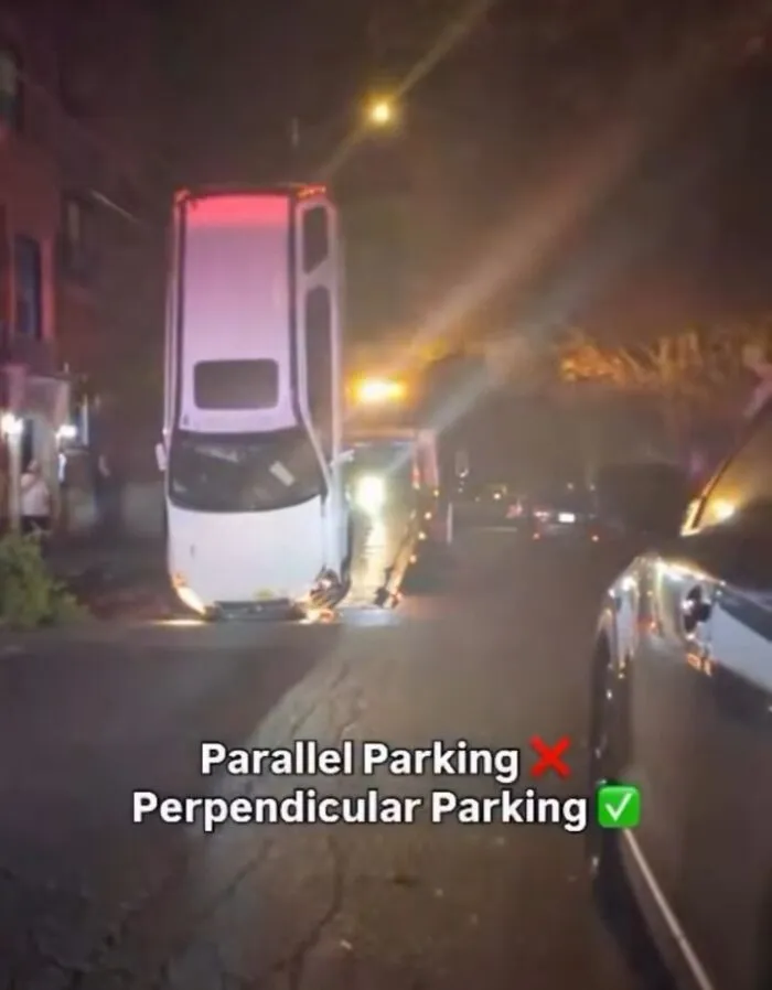 White car humorously parked vertically on street at night with meme text about parallel and perpendicular parking fails.