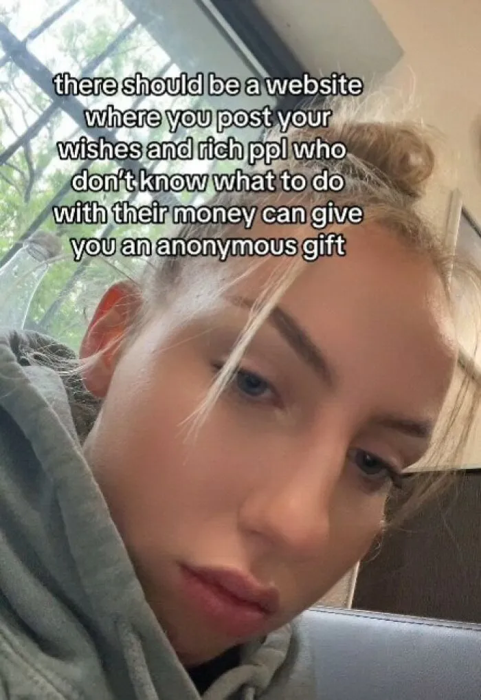 Close-up of a person with a meme about a website for posting wishes and receiving anonymous gifts, entertaining meme content.