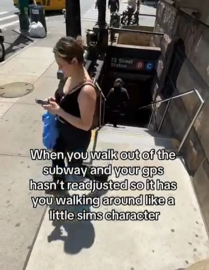 Woman standing near subway entrance looking at phone, representing memes to function properly with GPS humor.