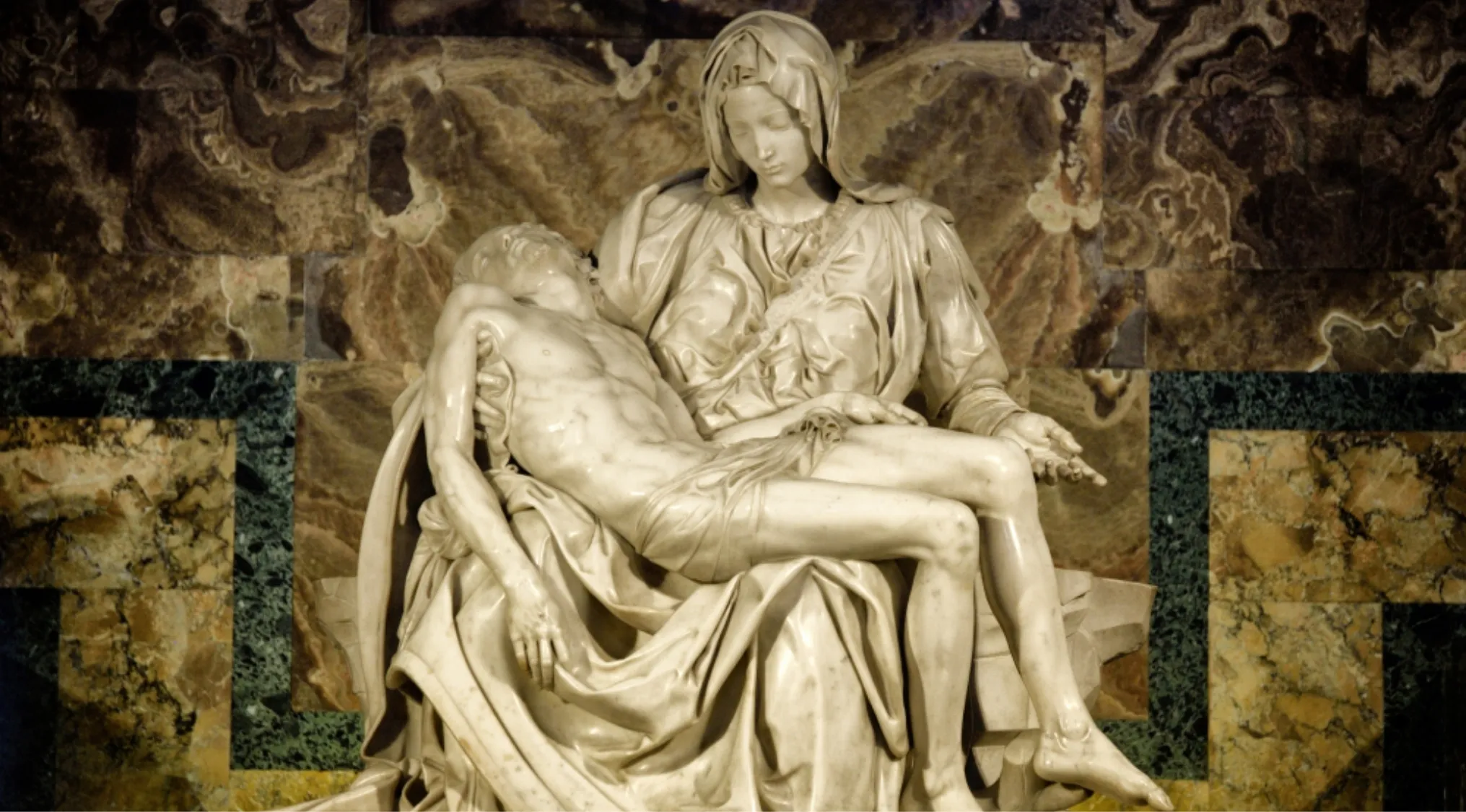 Marble sculpture of the Pietà depicting Mary holding Jesus, an iconic work by the artist Michelangelo.