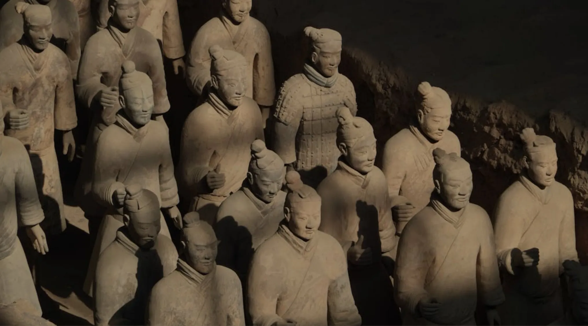 Terracotta Army statues in China, showing detailed ancient clay soldiers standing in formation underground.