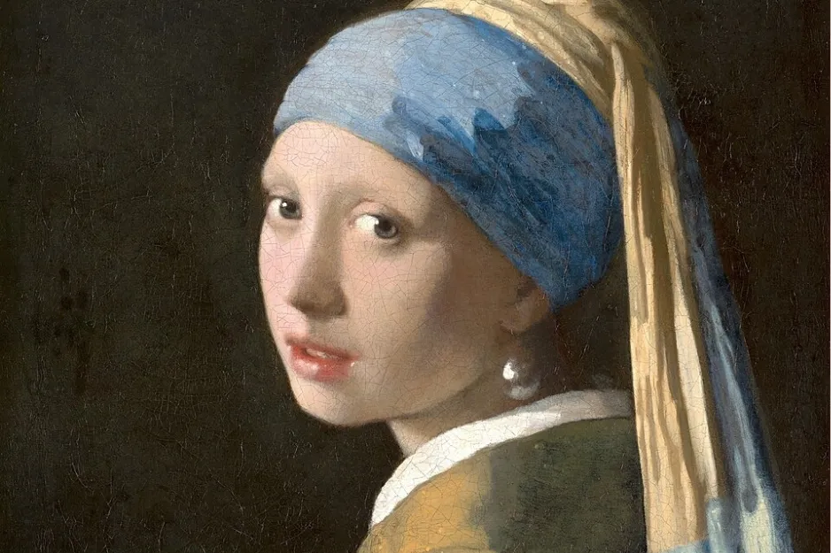 Girl with a Pearl Earring painting showing a young woman wearing a blue and yellow headscarf with a pearl earring.
