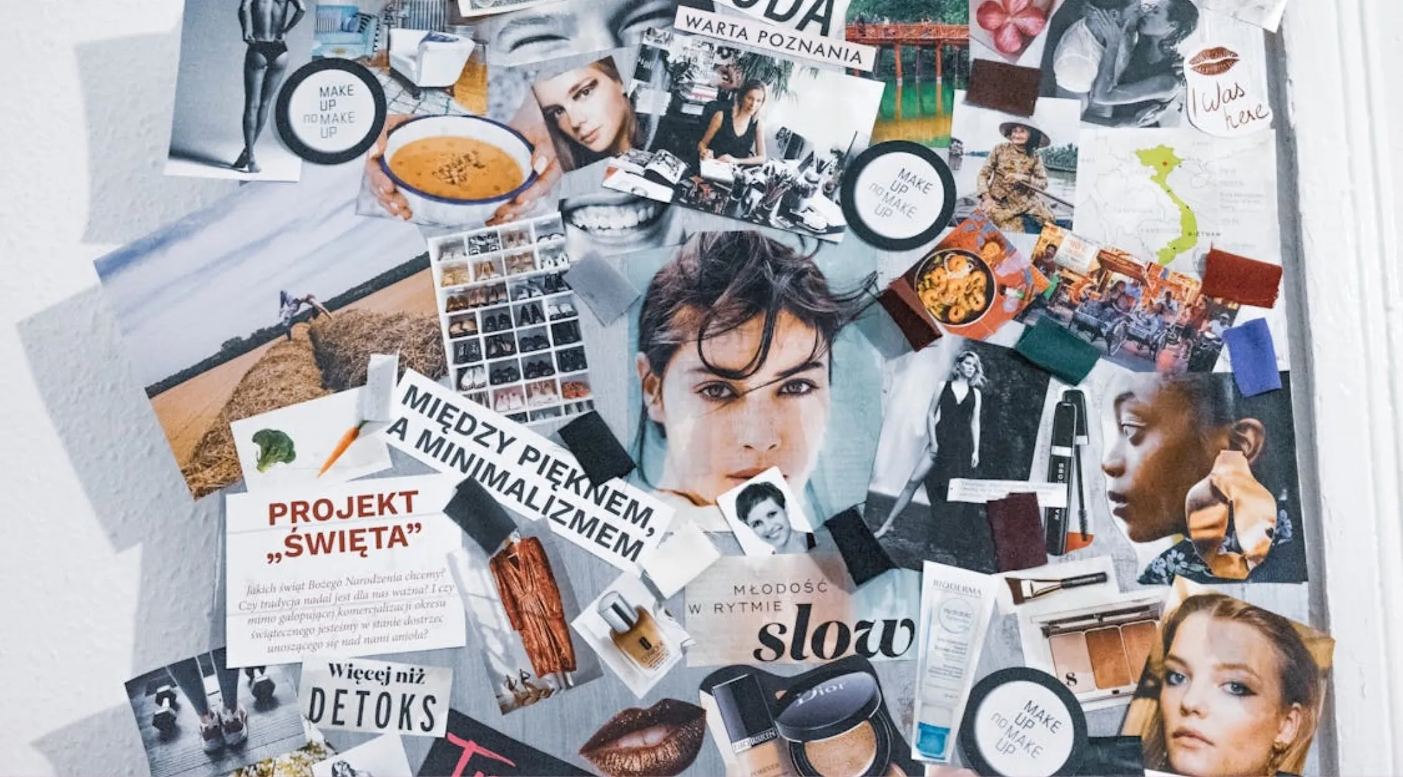 Collage art form featuring various magazine cutouts, photos, and text pieces arranged on a board.