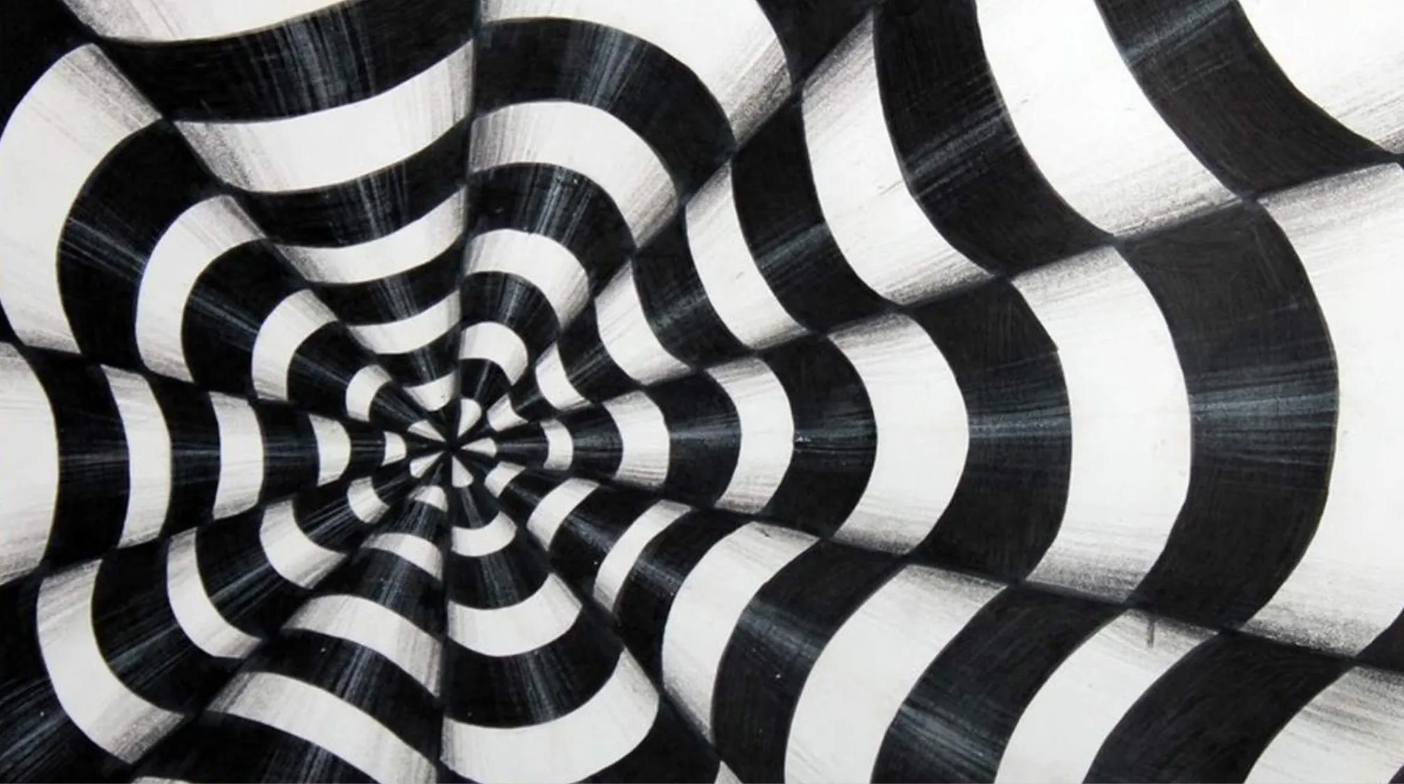Black and white Op Art pattern creating an optical illusion with wavy concentric circles drawing the eye inward.