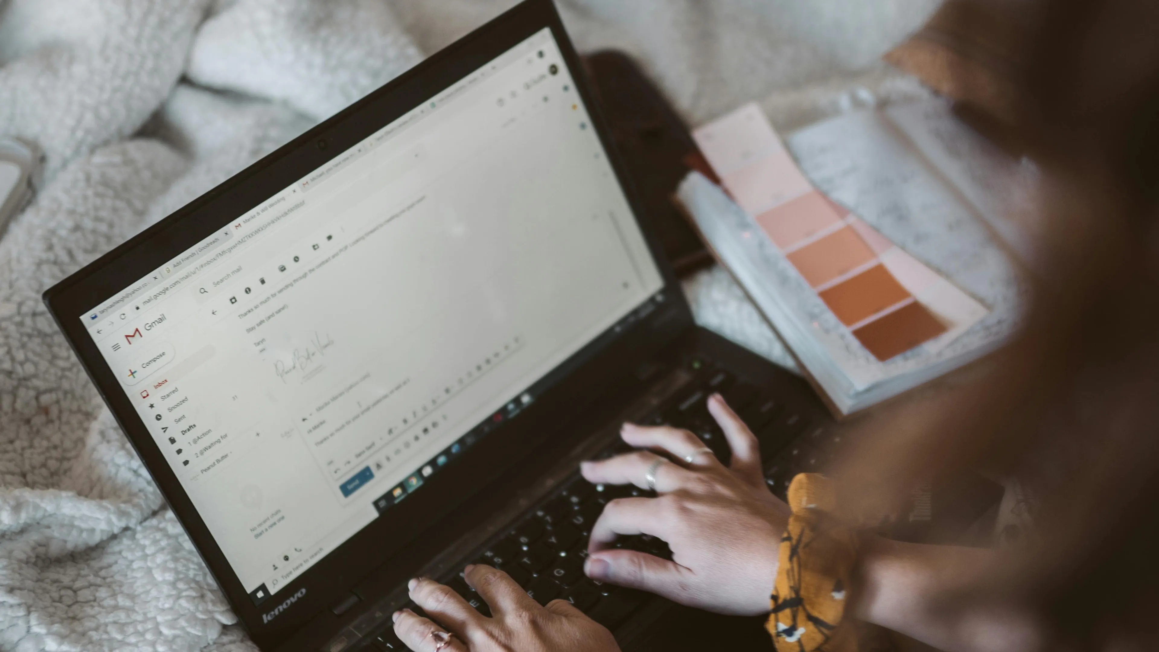 Person typing an email on a laptop using Gmail focusing on professional and appropriate BCC email scenarios.