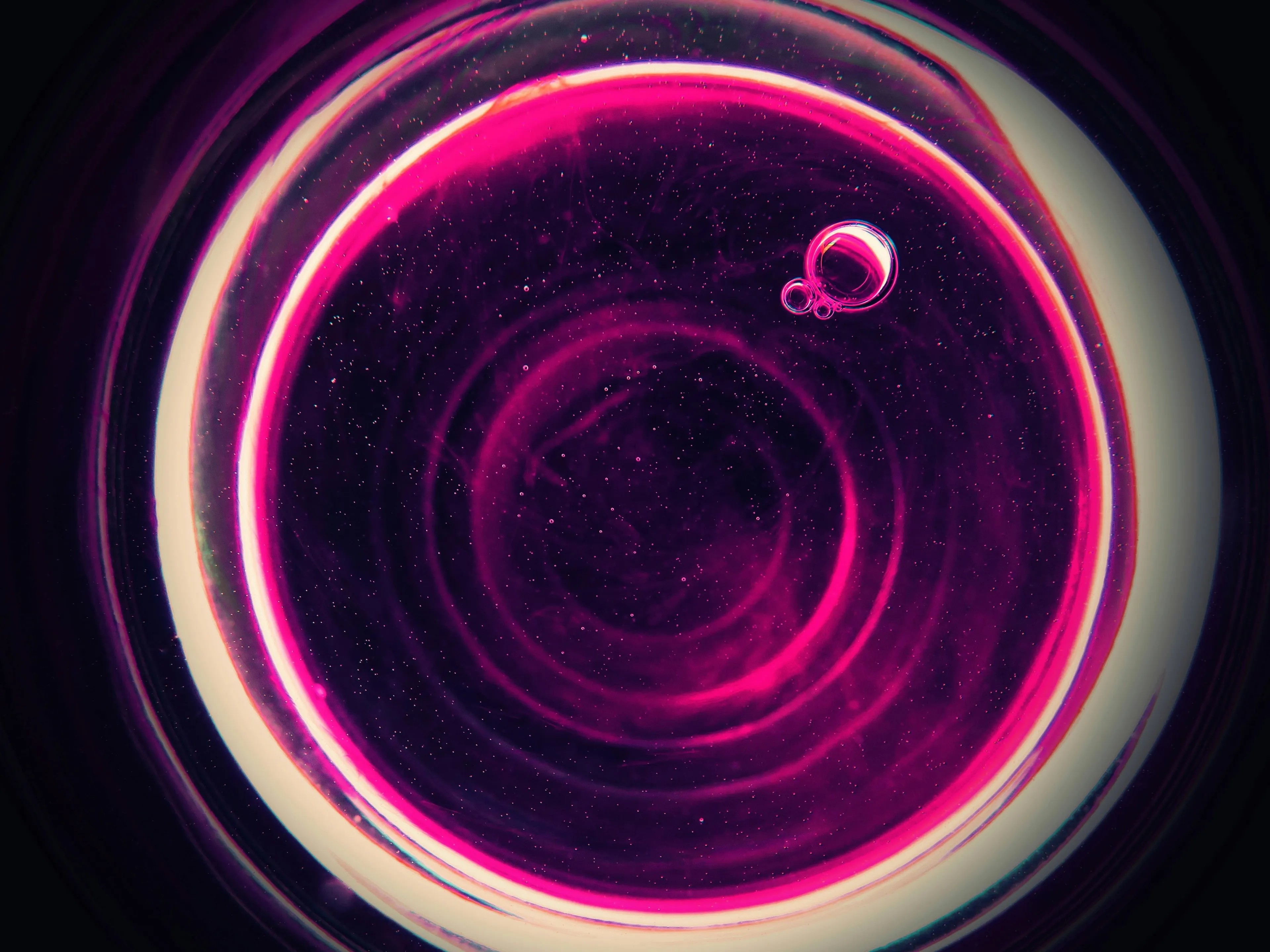 Abstract circular pattern with vibrant purple and pink hues, illustrating science concept related to sound travel through a vacuum.
