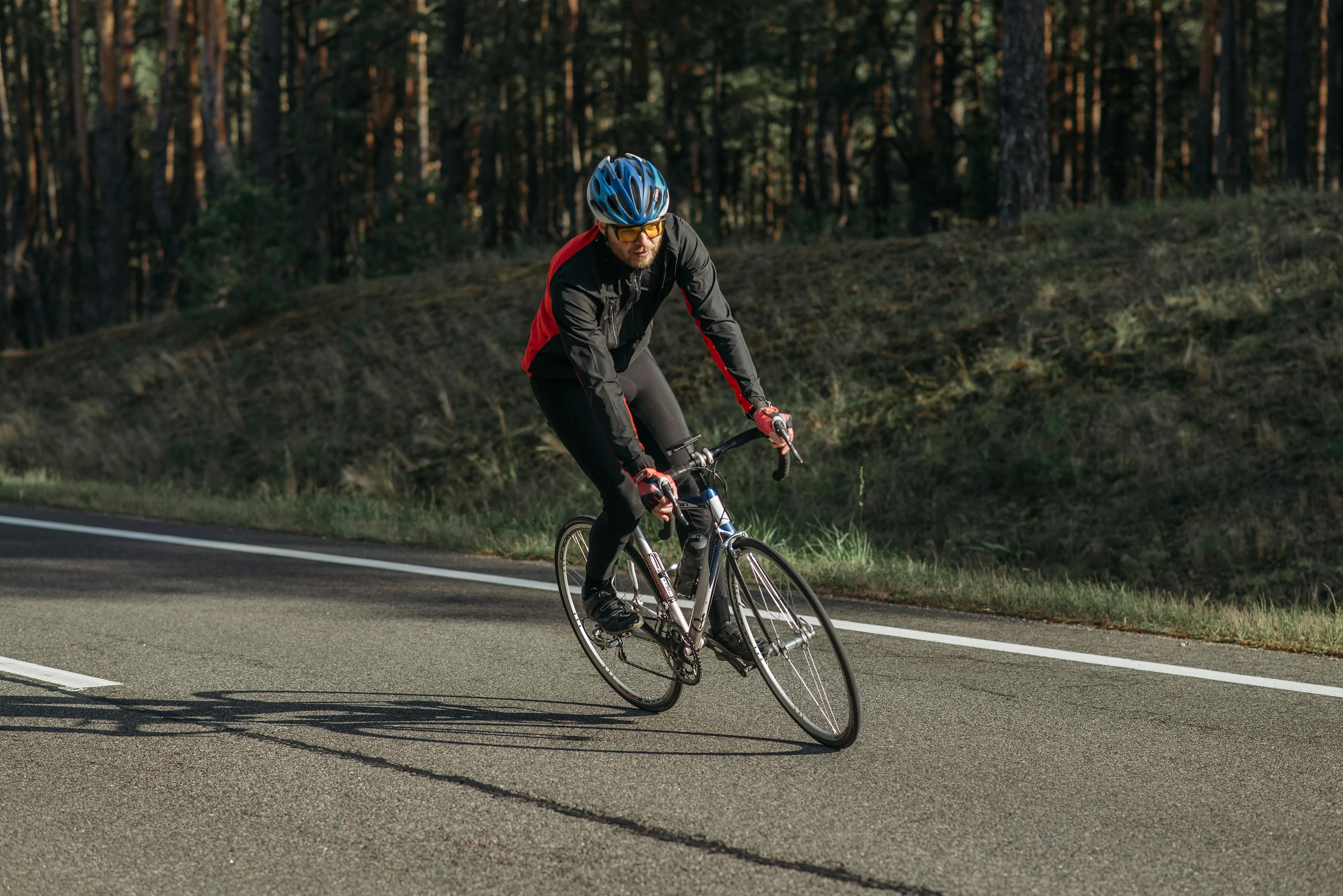 Cyclist leaning into a curve on a road race, demonstrating the force responsible for balance and turning in general science.