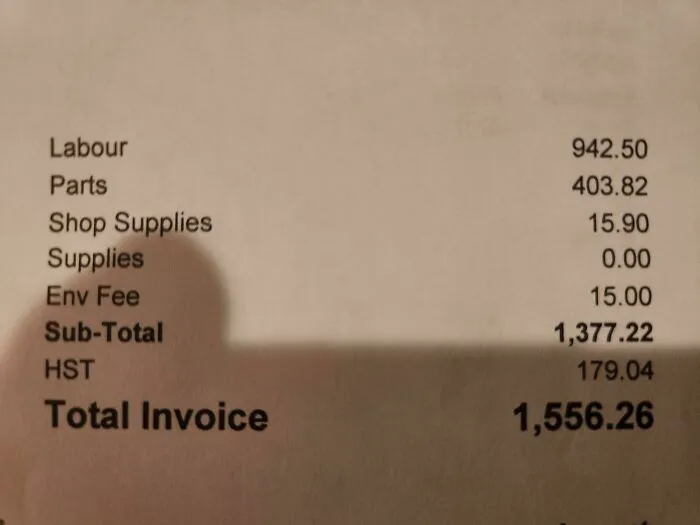 A close-up of an invoice showing labour, parts, and total amounts, capturing a great dad's financial responsibilities.