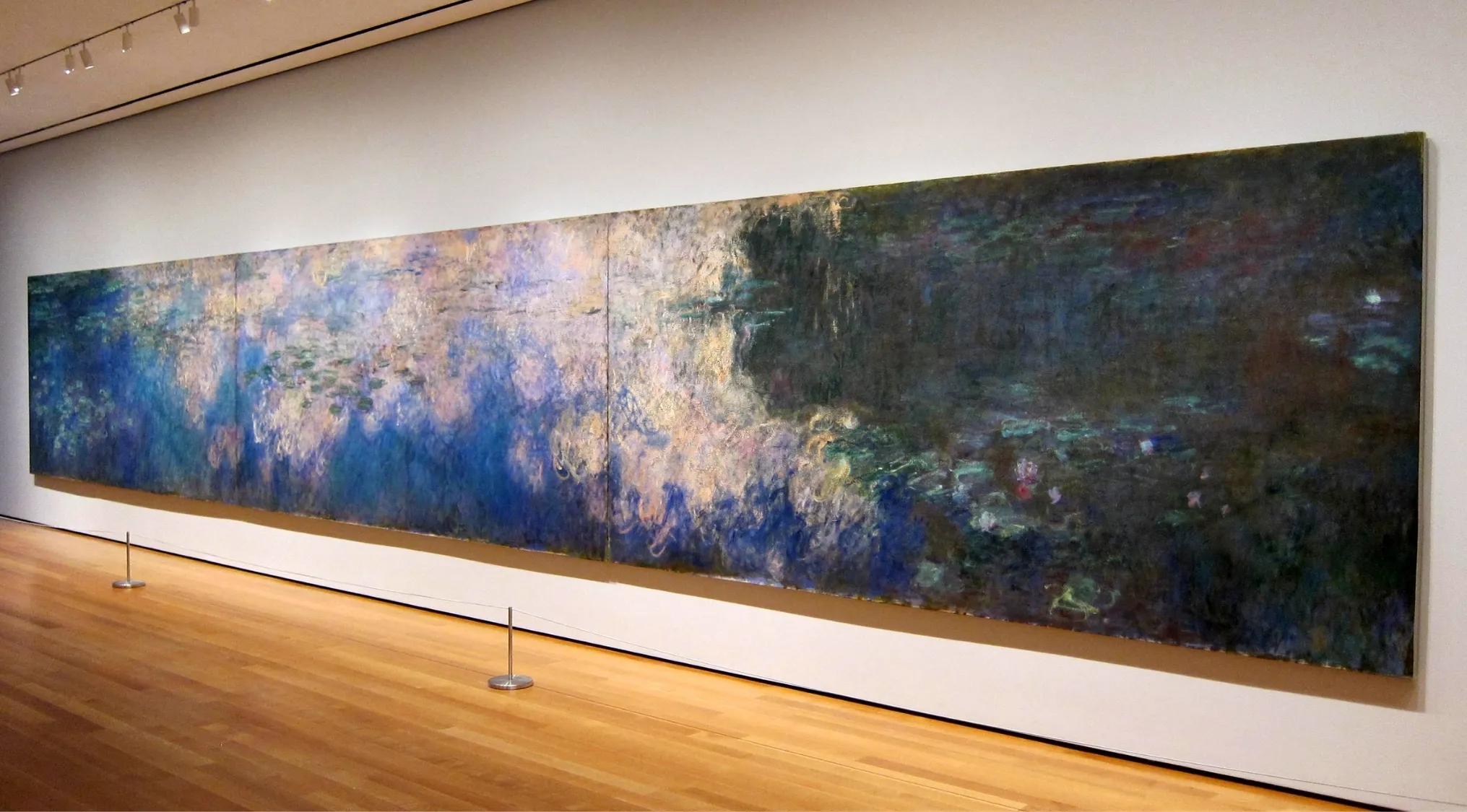 Long abstract painting displayed in a museum gallery, featuring soft blue and dark tones, for general knowledge quiz on who painted this.