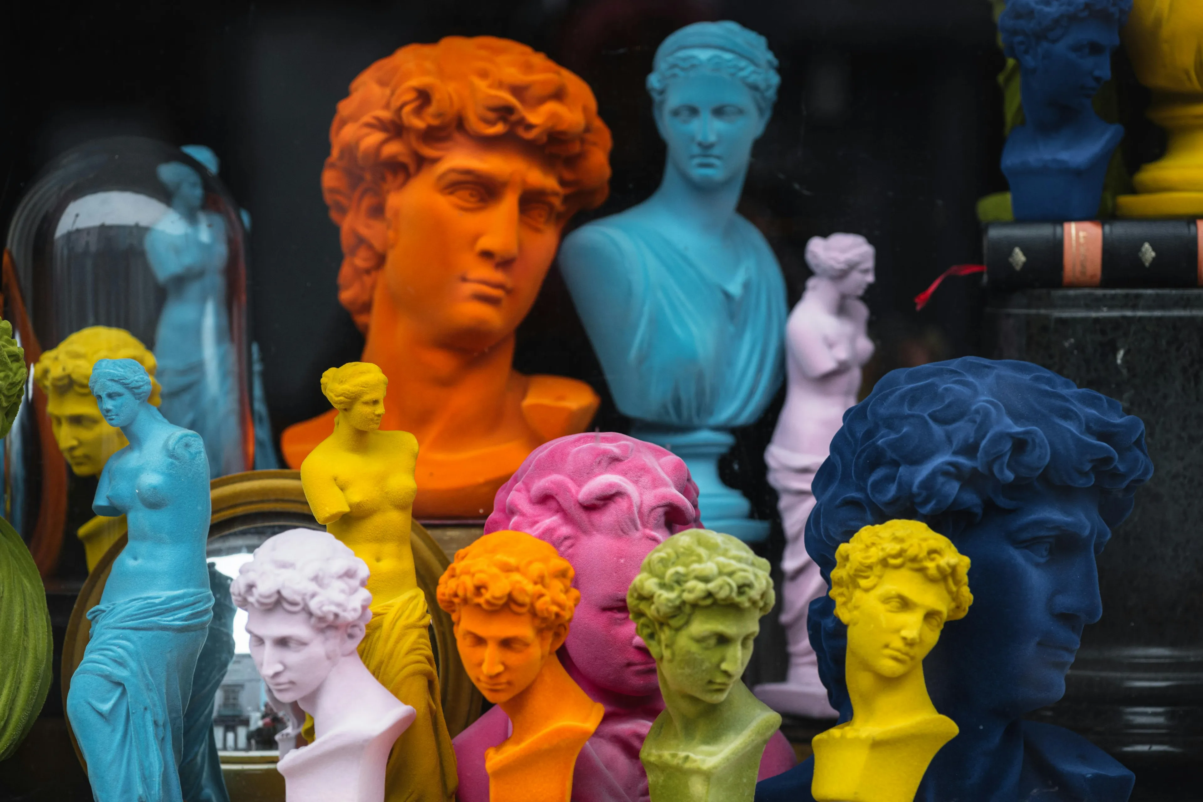 Colorful Roman mythology busts and statues in various vibrant colors, representing gods and figures in a general knowledge quiz.